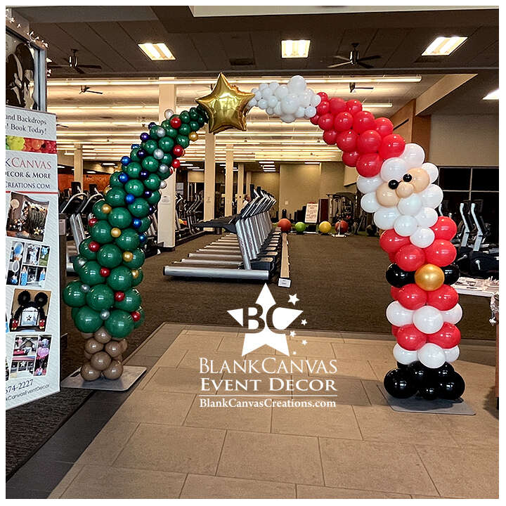 Christmas Balloon Sculpture Arch with Santa on one side and a Christmas tree on the other